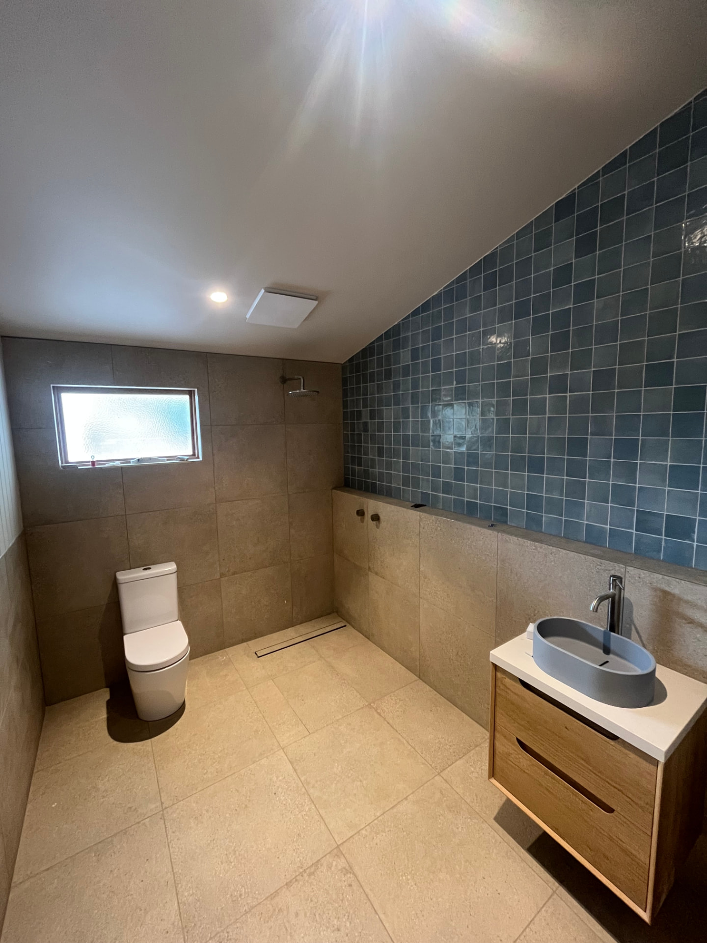 Modern bathroom renovation with feature tiling and walk-in shower